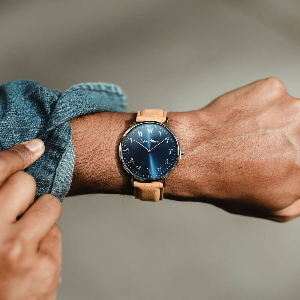 Arabic Numerals Watch with Tan Leather Strap and Navy Blue Dial by Crscnt Moon shown being worn