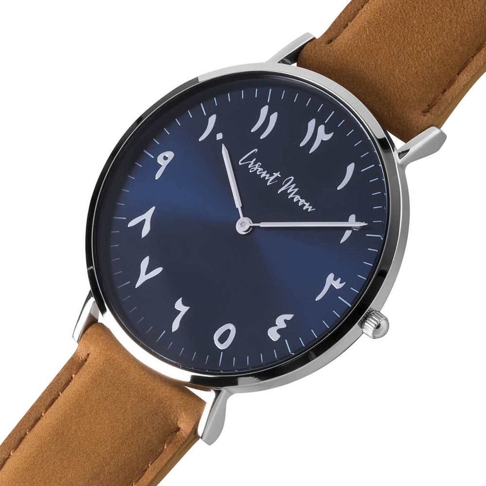 Arabic Numeral Watch with Tan Leather Strap, Silver Case, and Blue Dial by Crscnt Moon. Side Angle Photo.